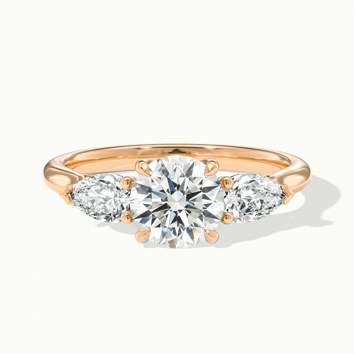 Amaya 2.5 Carat Round 3 Stone Moissanite Diamond Ring With Pear Side Stone in 14k Rose Gold