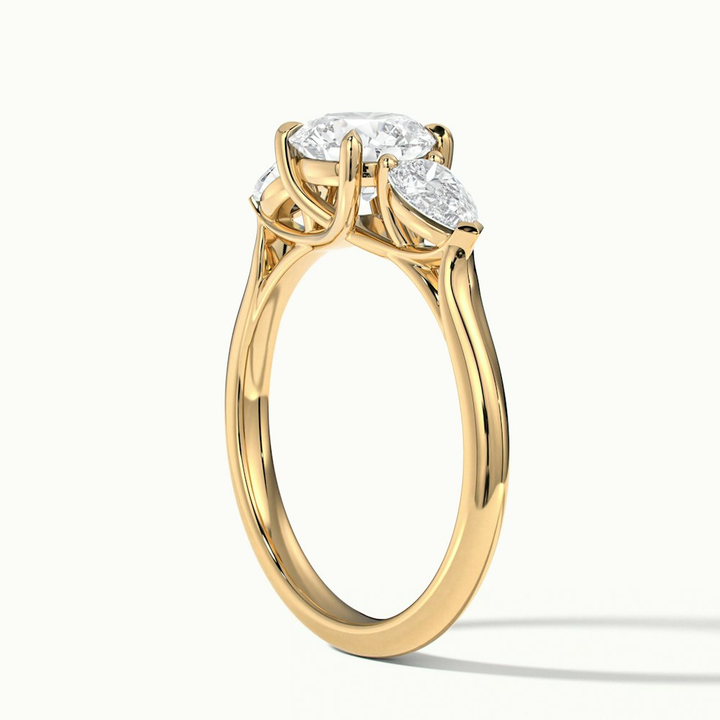 Amaya 3.5 Carat Round 3 Stone Moissanite Diamond Ring With Pear Side Stone in 18k Yellow Gold